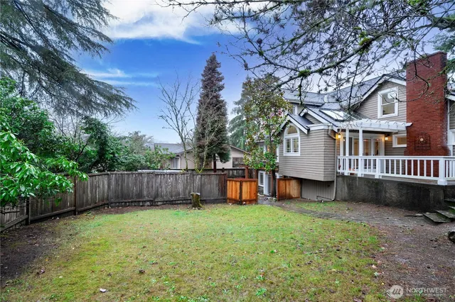 a view of a house with a yard and sitting area