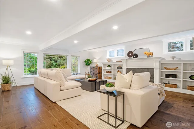 a living room with furniture fireplace and wooden floor