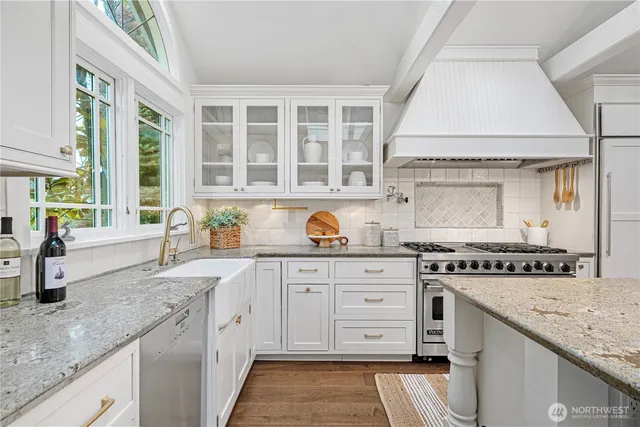 a kitchen with stainless steel appliances granite countertop a stove and a sink