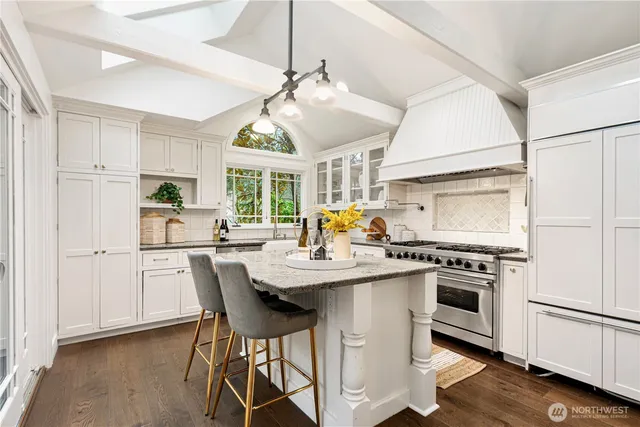 a kitchen with a stove a sink and a refrigerator
