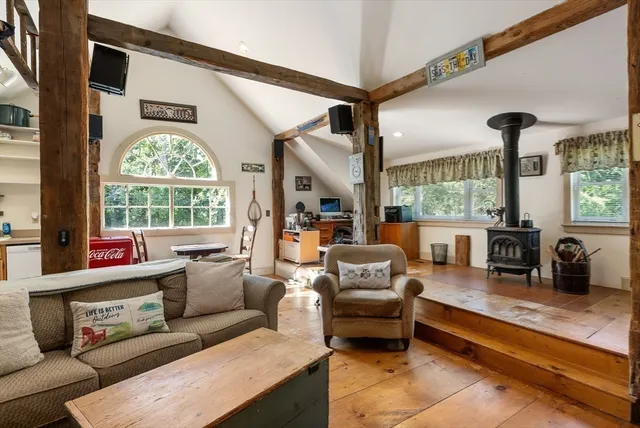 a living room with furniture a large window and a clock
