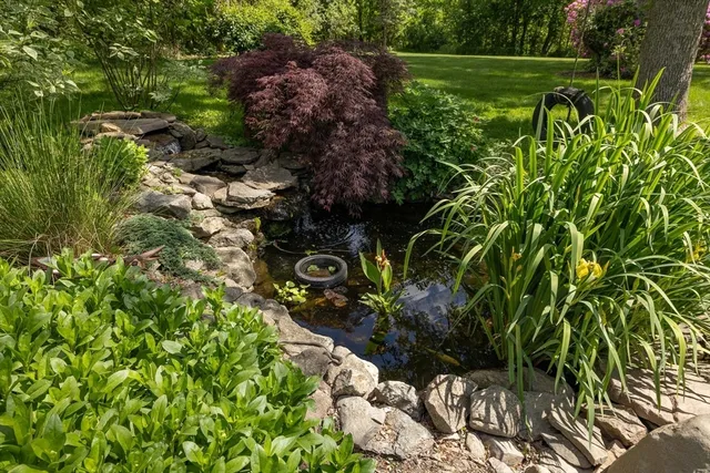 an aerial view of residential house with space and trees all around