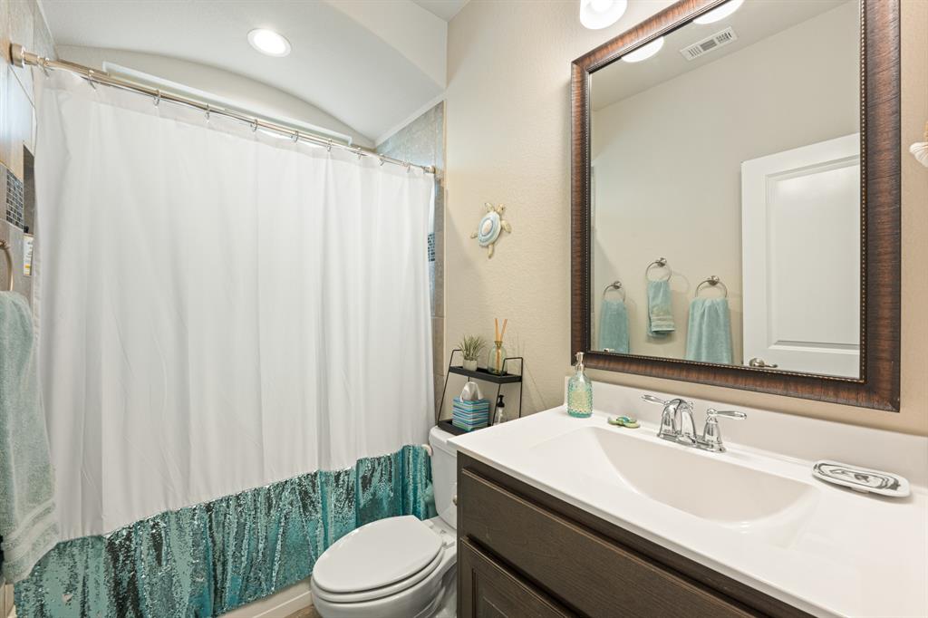 916 Falcon Road Argyle, TX 76226 - Photo 11 of 37 Bathroom featuring vanity, vaulted ceiling, and toilet