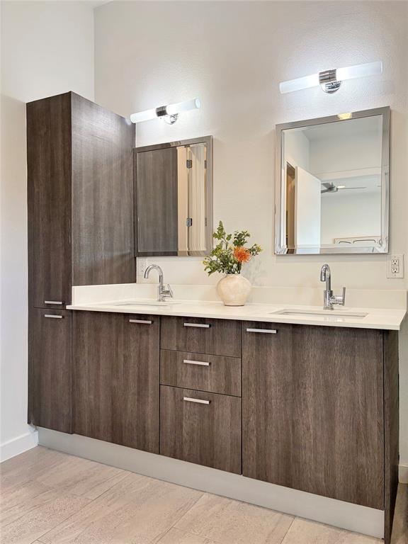 4934 Zuma Court Dallas, TX 75206 - Photo 12 of 22 a bathroom with a double vanity sink and mirror
