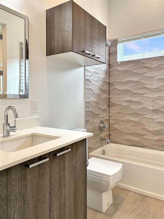 4934 Zuma Court Dallas, TX 75206 - Photo 15 of 22 a bathroom with a sink a toilet and shower