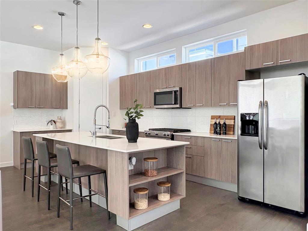 4934 Zuma Court Dallas, TX 75206 - Photo 4 of 22 a kitchen with kitchen island a sink stainless steel appliances and cabinets