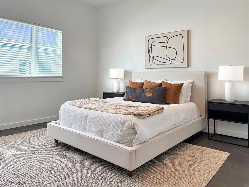 4934 Zuma Court Dallas, TX 75206 - Photo 8 of 22 a large bed sitting in a bedroom next to a window