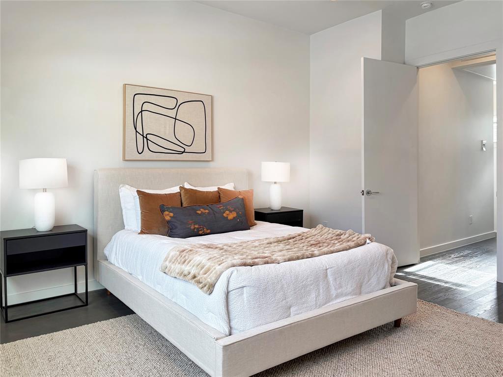 4934 Zuma Court Dallas, TX 75206 - Photo 9 of 22 a bedroom with a bed and a lamp