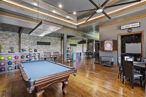 a living room with pool table and a flat screen tv