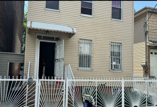 a view of a house with a small deck