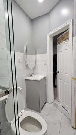 a bathroom with a toilet and a mirror