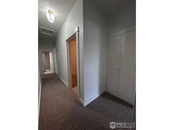 a view of a hallway with closet
