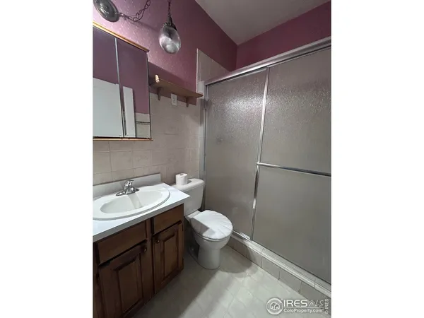 a bathroom with a toilet sink and a mirror