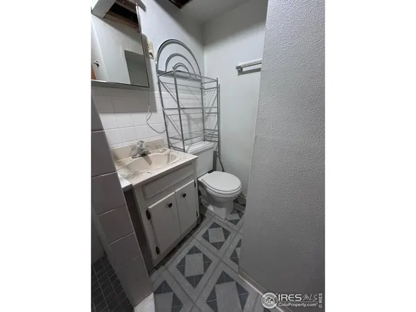 a bathroom with a sink toilet and a mirror