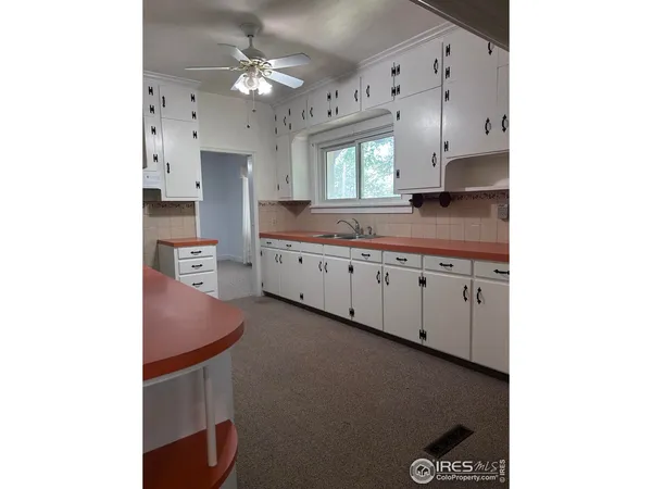a spacious bathroom with a double vanity sink and a mirror