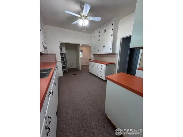a kitchen with a refrigerator and a sink