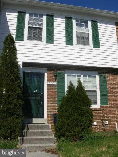 a view of a house with more windows and brick walls