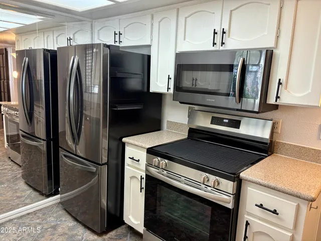 a kitchen with granite countertop a stainless steel appliances and cabinets