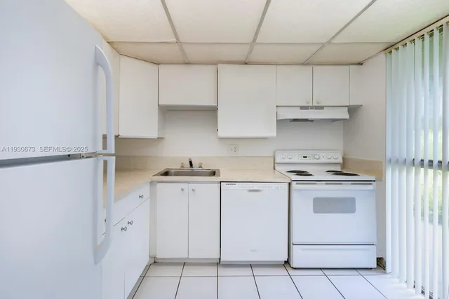 a kitchen with cabinets appliances and a sink