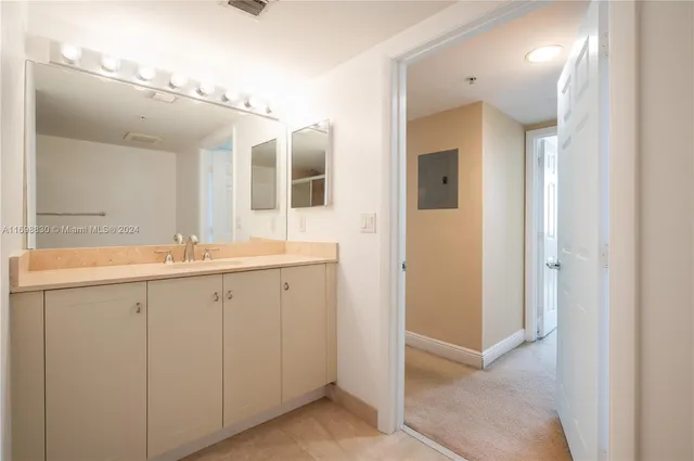 a spacious bathroom with a double vanity sink and mirror