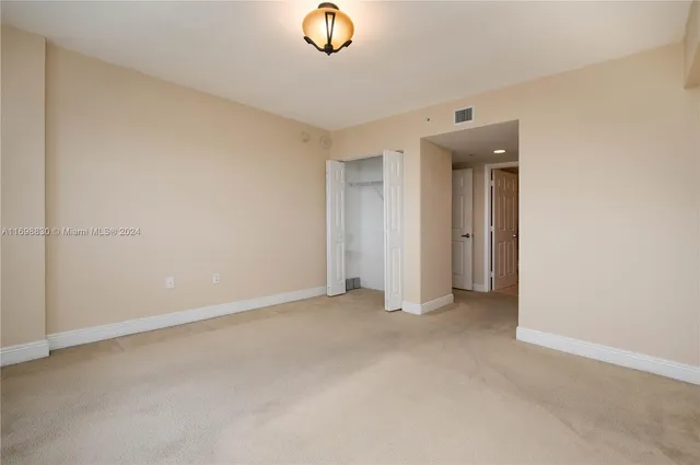 an empty room with closet area