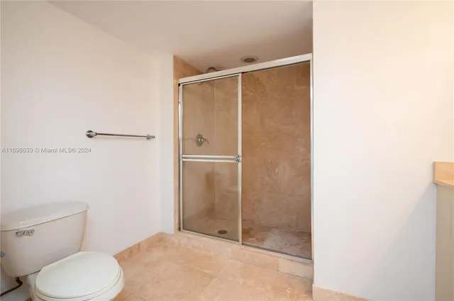 a bathroom with a toilet and a shower