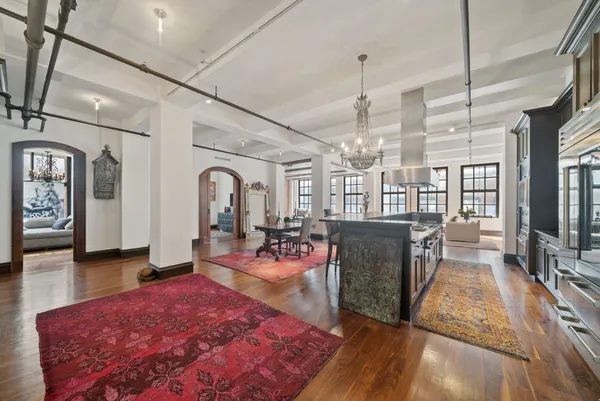 a living room with fireplace furniture and a wooden floor