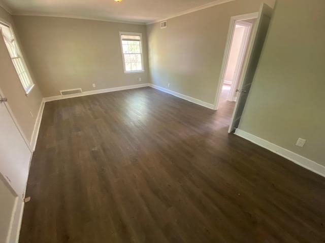 4128 Michael Road Memphis, TN 38116 - Photo 2 of 11 an empty room with wooden floor and windows
