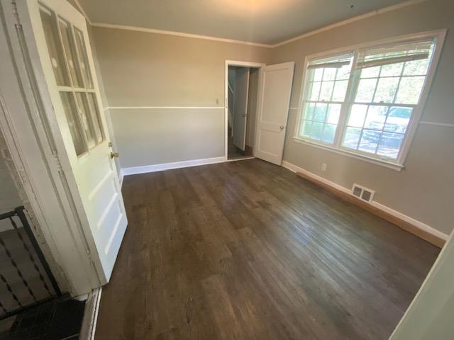 4128 Michael Road Memphis, TN 38116 - Photo 7 of 11 a view of an empty room with wooden floor and a window