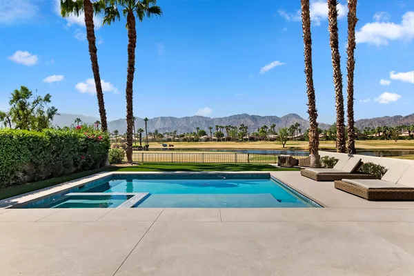 a view of swimming pool with a table and chairs
