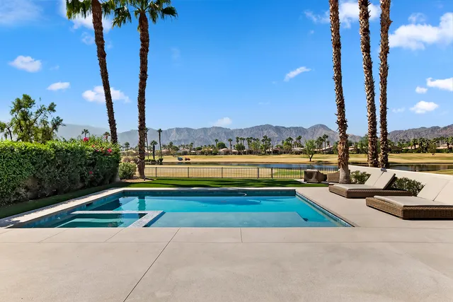 a view of swimming pool with a table and chairs