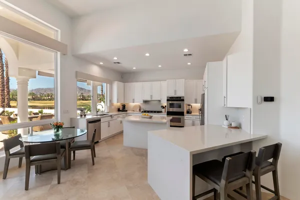 a kitchen with a sink a counter top space and appliances