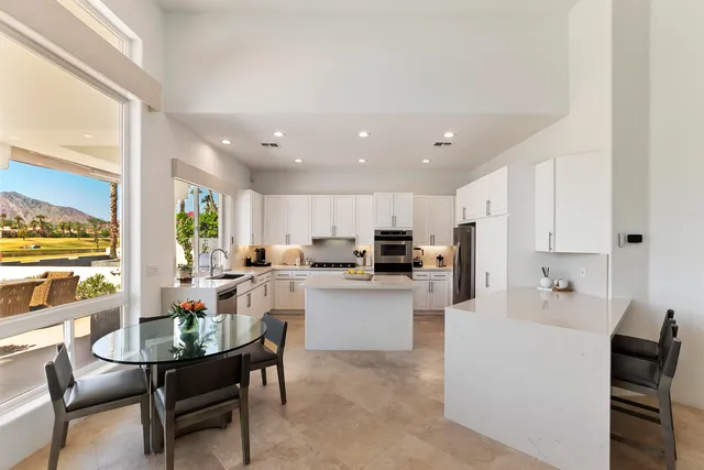 a living room with stainless steel appliances kitchen island granite countertop furniture and a kitchen view