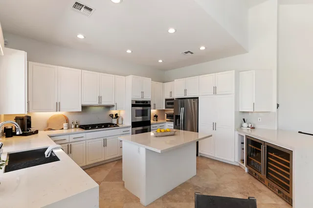 a kitchen with refrigerator a stove and cabinets