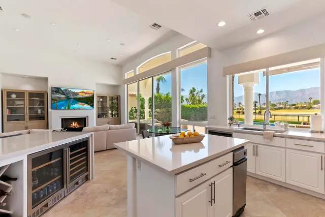 a kitchen with a sink a counter top space and stainless steel appliances