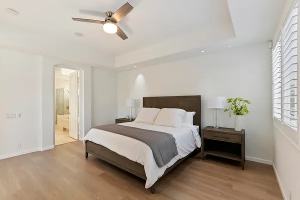 a bedroom with a bed and a chandelier