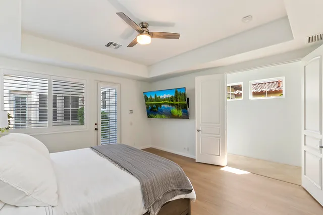 a bedroom with a bed and a large window