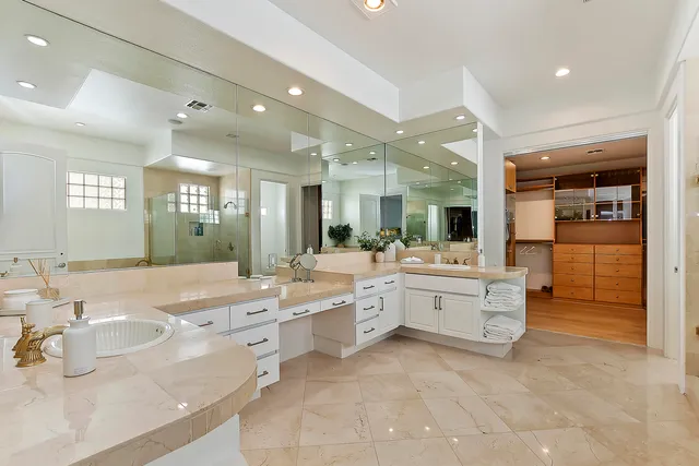 a large bathroom with a large tub and sink