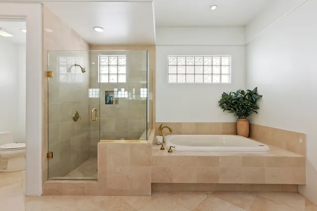 a bathroom with a bathtub and shower