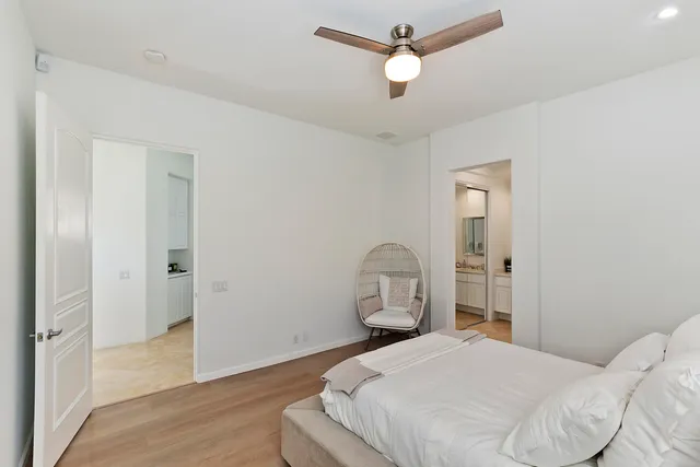 a bedroom with a bed and wooden floor