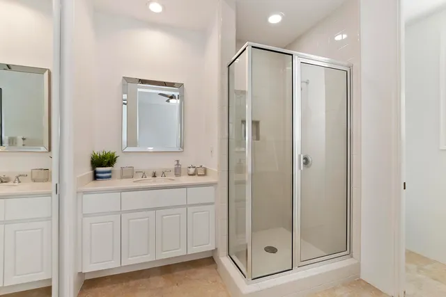 a bathroom with a shower sink and mirror