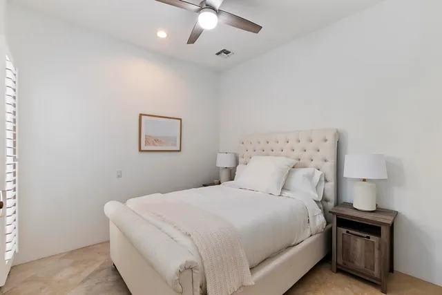 a bedroom with a bed and a lamp