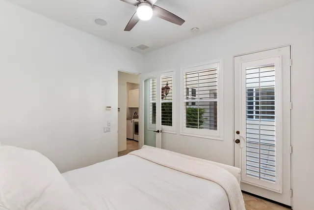 a bedroom with a large bed and a window