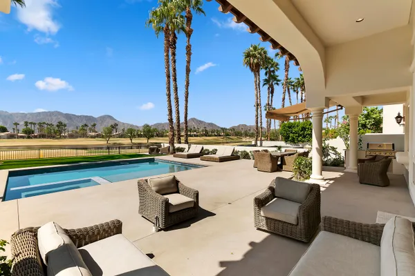 a view of a swimming pool with couches and city view