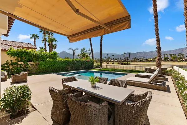 a view of an outdoor sitting area with furniture and city view