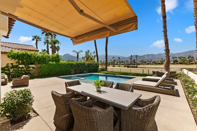 a view of an outdoor sitting area with furniture and city view