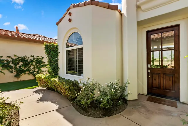 a view of a house with a small yard and a potted plant