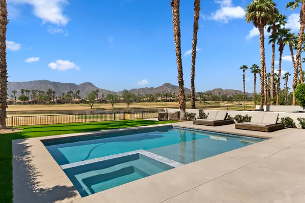 a view of swimming pool with outdoor seating and city view