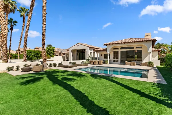 a front view of a house with a yard table and chairs