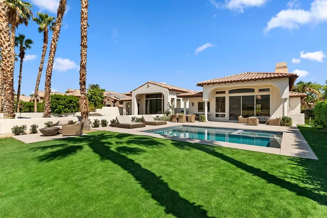 a front view of a house with a yard table and chairs